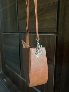Tan brown half moon sling bag