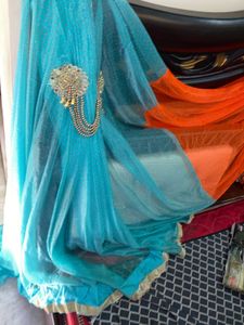 Stunning Blue and orange Net saree with Embellishm