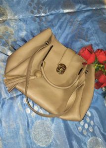 Stylish Beige Handbag with Tassel Accent