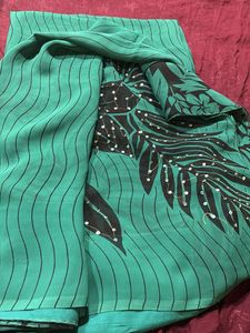 Elegant Green Saree with Black Floral Print