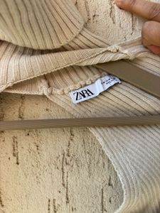 Cream Ribbed Turtleneck Sweater Arms