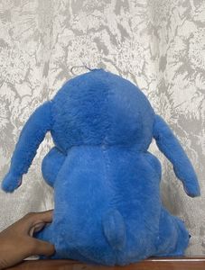 Stitch holding a duck plushie!