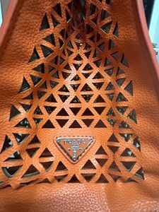 An orange Prada Bag