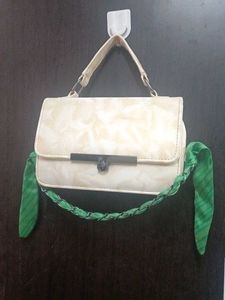 Chic Cream Textured Handbag with Green Scarf Accen