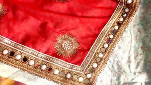 Red saree with mirror work border