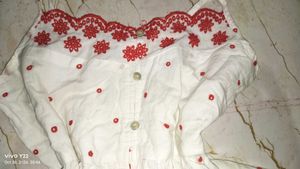White top with red embroidery