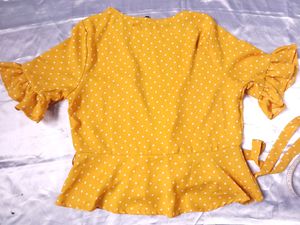 polka dot yellow wrap top.