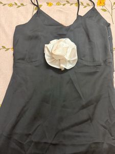Elegant Black Dress with Floral Accent