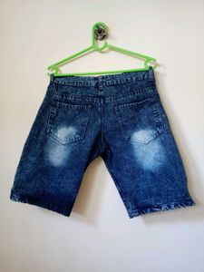 Casual distressed blue denim shorts.