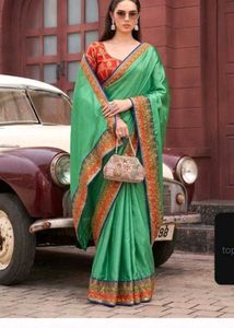Title: Emerald Elegance: Lustrous Green Silk Saree