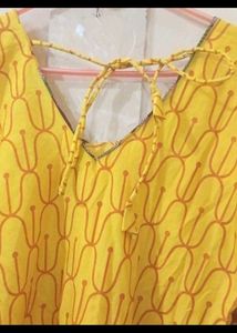 a )Yellow Printed Kurti with knot at back
