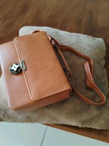 Stylish Tan Handbag with Flower Clasp
