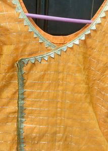 Orange kurta with golden border nakki lace
