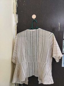 shrug in beige colour