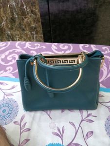 Stylish Teal Handbag with Gold Accents