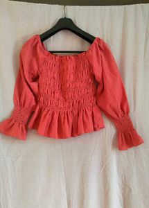 Coral Smocked Peplum Top