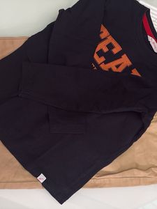 one black T-shirt with beige trousers