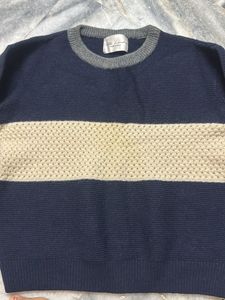a knit sweater in shades of navy blue and beige