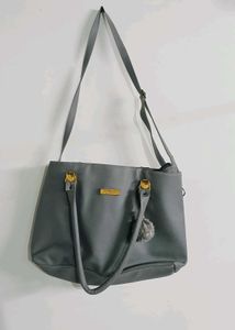 Stylish Grey Tote Bag with Pom-Pom Accent