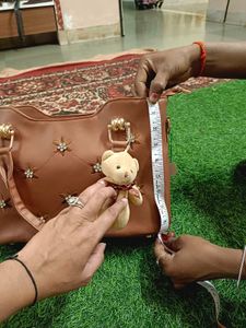 Elegant Brown Handbag with Floral Accents