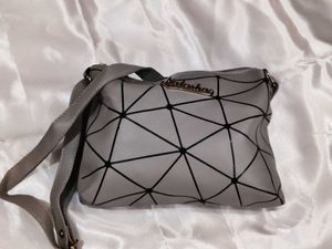 Grey geometric sling bag