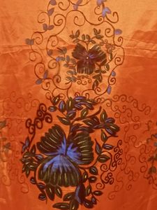 Orange colour dress material with Floral Border