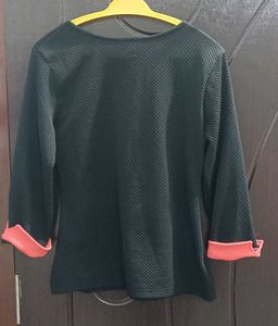 Chic Black Textured Top with Coral Cuffs