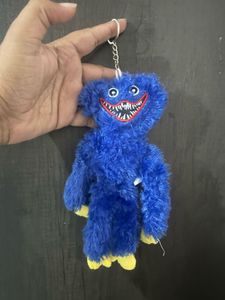 A blue Huggy Wuggy plush keychain from the horror