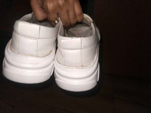 White slip-on shoes with embellishments
