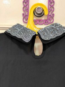 Chic Black Top with Embellished Collar