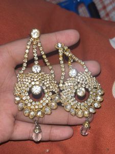 stylish indian earing with a pearl choker and ring
