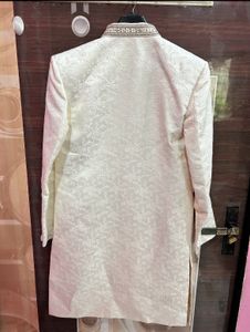 Men’s white sherwani with red velvet dhoti