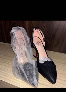 Stylish Black Heels with Pom-Pom Accent