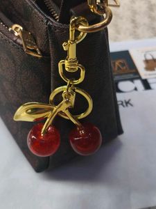 Coach Signature Brown  with cherry charm 🍒
