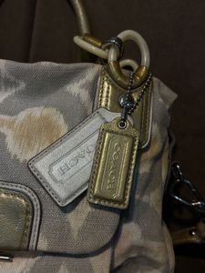 Chic Coach Shoulder Bag with Gold Accents