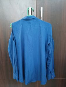 Royal Blue Top With Cold Shoulder Style. Can Be Styled Up For Office And Party Both. Bottom Style Of the Top Is High Low Style.