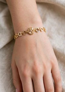 Elegant Gold Bracelet with Heart & Flower Design