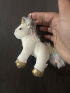 This white unicorn plush keychain features a shim