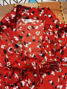Chic Red Abstract Print Blouse with Bow