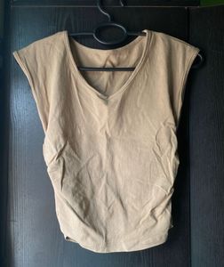 Beige/tan sleeveless top with a V-neck