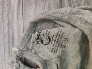 Bundle of baby clothes, beanie, shoes.