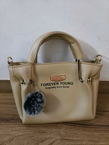 FOREVER YOUNG Beige Handbag with Pom Po