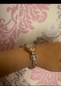 Elegant Gold Tone Watch with Charm