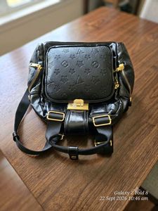 Chic Black Patent Clutch Bag with gold detailing.