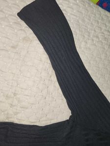 The image features a black ribbed top characterize