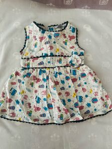 infant's white sleeveless cotton muslin frock
