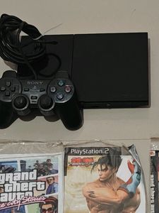 PS2 Console With 11 CD's (Non Working)