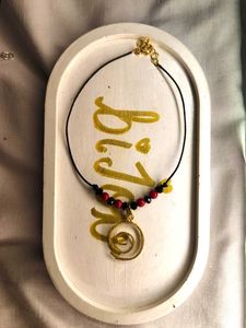 Balck and red beads with golden spiral