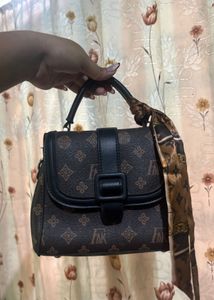 Chic Monogram Handbag with Scarf Accent