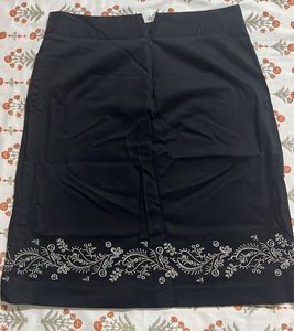Chic Black Skirt with Embroidered Hem